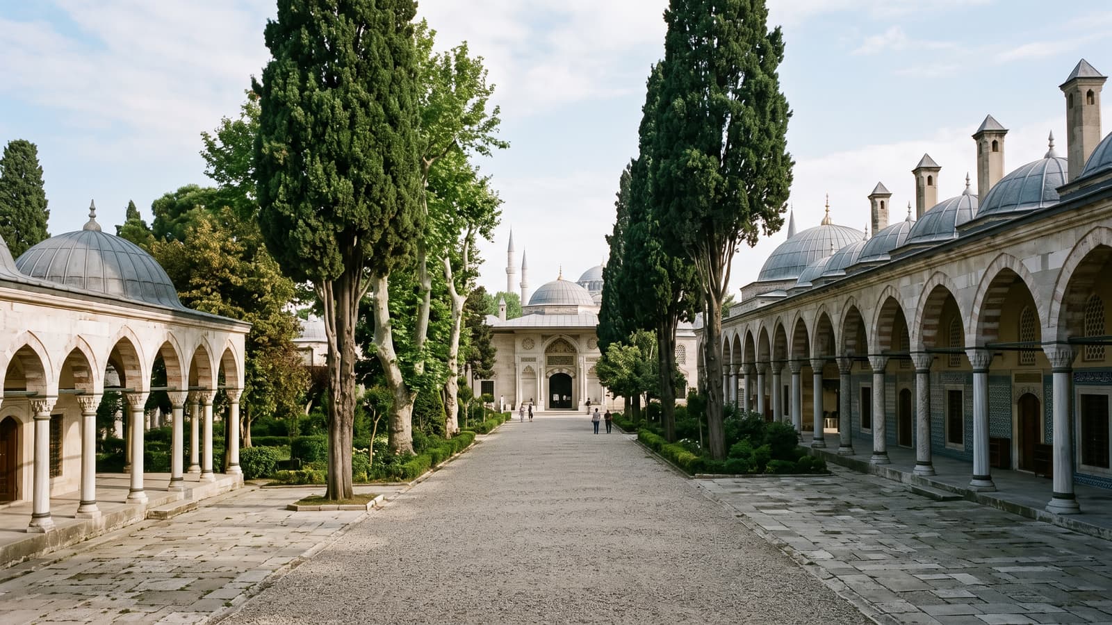 Second courtyard of Topkapı Palace with cypress trees and Ottoman porticoes in morning light